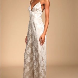 Lace-up detail. Wide pant legs fall to a full length. Hidden back zipper/clasp.